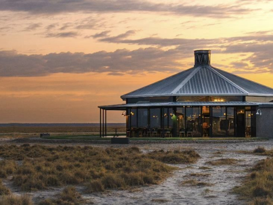 A striking architectural structure set against a colorful sky.