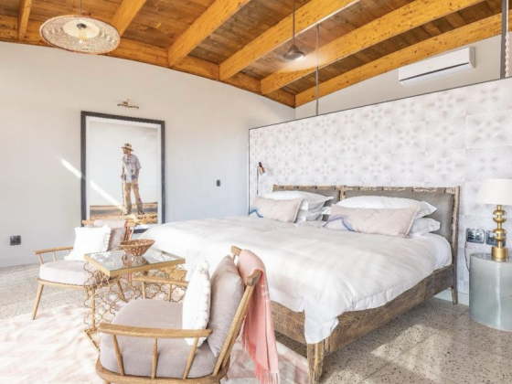 Bright bedroom featuring a cozy bed and modern furnishings.