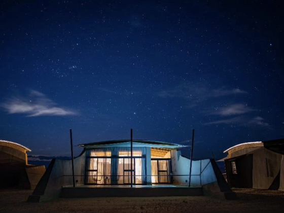 A serene cabin with starry skies above.