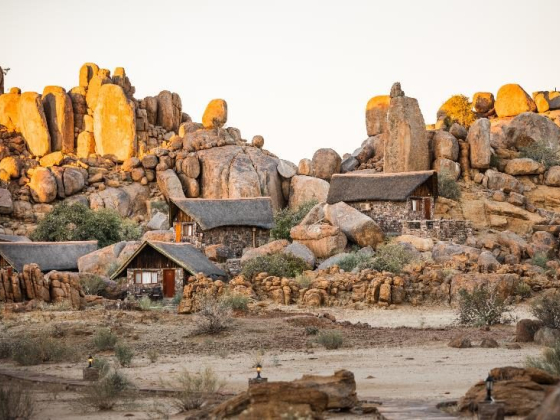Scenic view of unique lodges surrounded by large boulders.