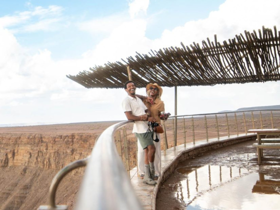 Happy couple enjoying a moment on a scenic viewpoint.