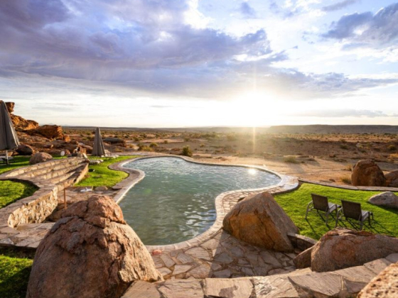 A tranquil pool surrounded by natural rock formations.
