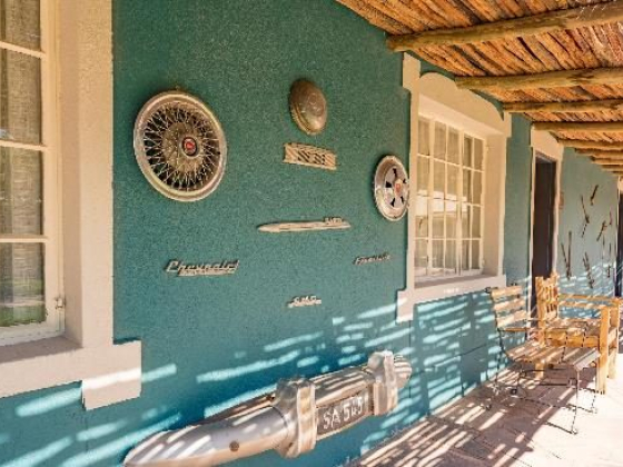 A colorful wall adorned with classic car emblems.