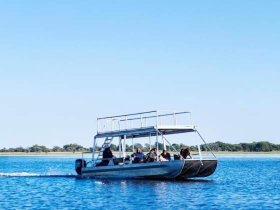 A group enjoys a scenic boat ride on a serene lake.