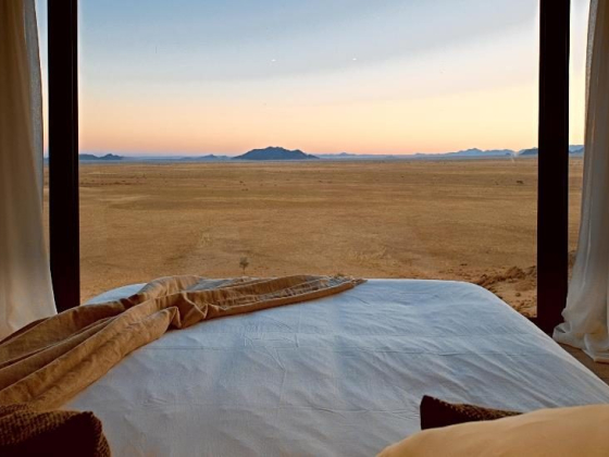 A serene landscape with mountains at sunset.