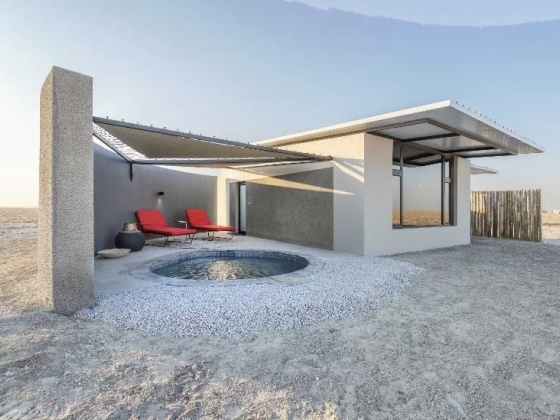 Stylish minimalist retreat in a sandy landscape.