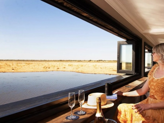 Relaxing interior scene with drinks and a stunning outdoor landscape.