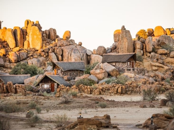Scenic view of unique lodges surrounded by large boulders.