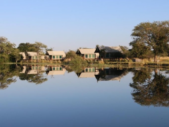 Scenic view of lodges by a tranquil lake.
