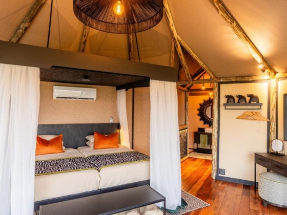 Chic tent bedroom with modern decor and cozy atmosphere.